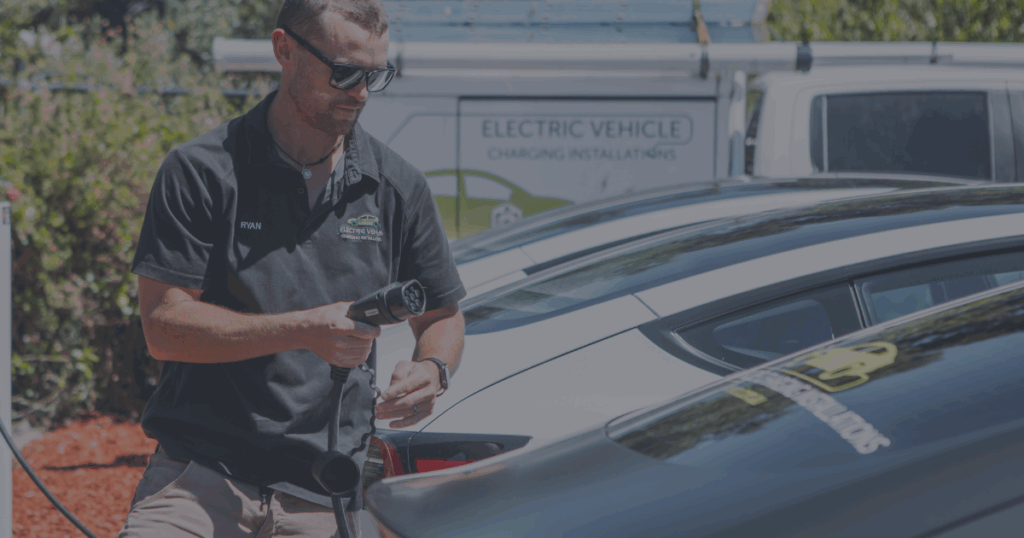 EV Electrician Perth | Director Ryan Gill standing in front of the EVCI Tesla