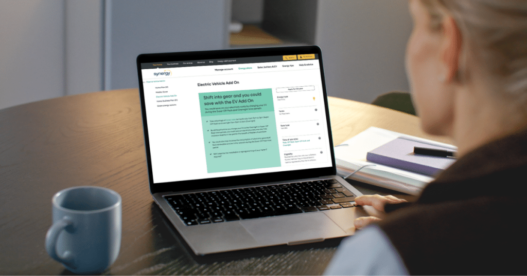 Homeowner reviewing the Synergy EV Add-On plan page on a laptop.