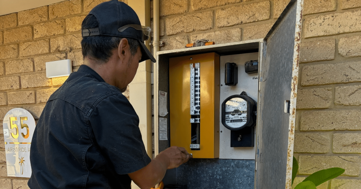 EVCI electrician working on a home switchboard and meter box during an EV charger installation in Perth